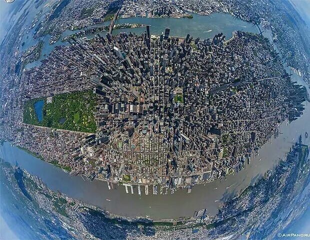 A breathtaking aerial view of Manhattan, New York, taken from a helicopter with a fish-eye lens.