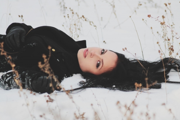 woman laying on snowy ground