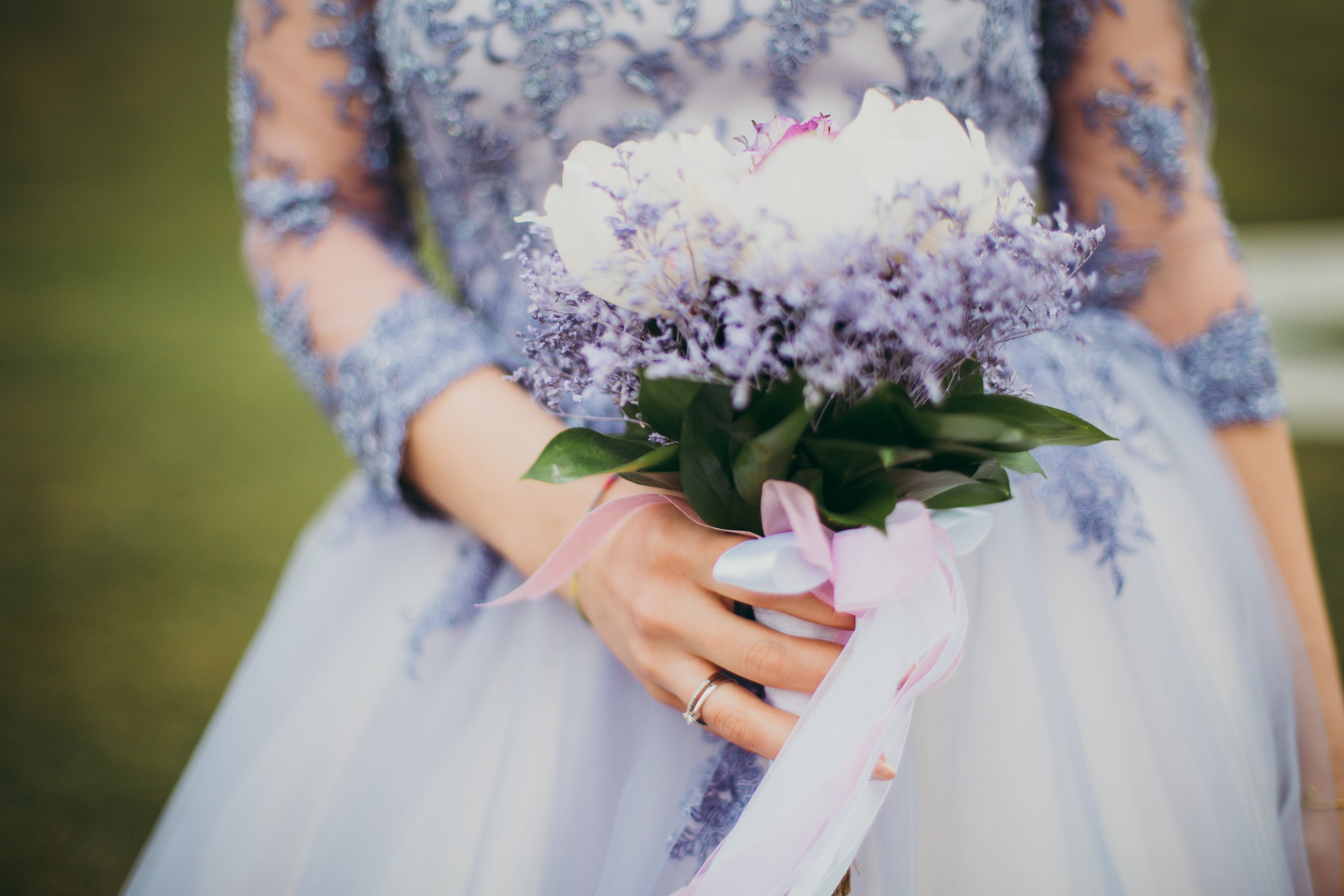 Woman in Blue Gown Holding Bouquet of Flowers