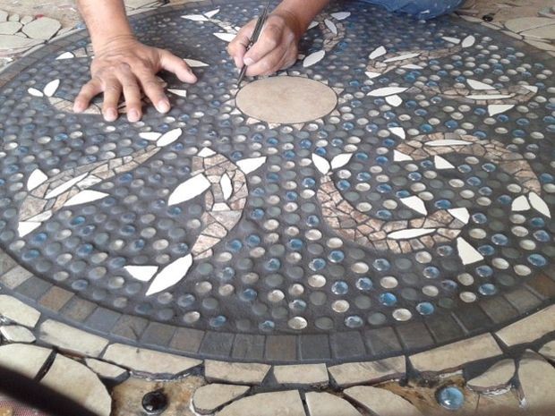 The inner circle was grouted first, and the glass stones had to be cleaned off afterwards to maintain their shine and color. Oops.