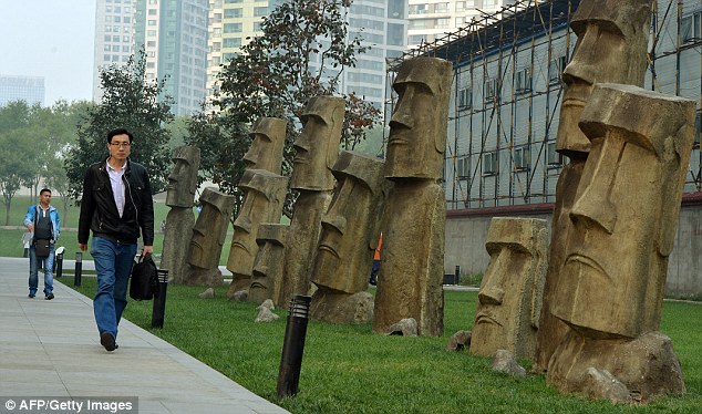 Beijing's replica 'Moai' statues, above, line a pedestrian walkway in one of the city's business districts