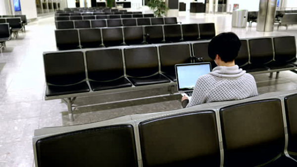 stock-video-62003854-woman-using-laptop-in-the-waiting-room-at-airport