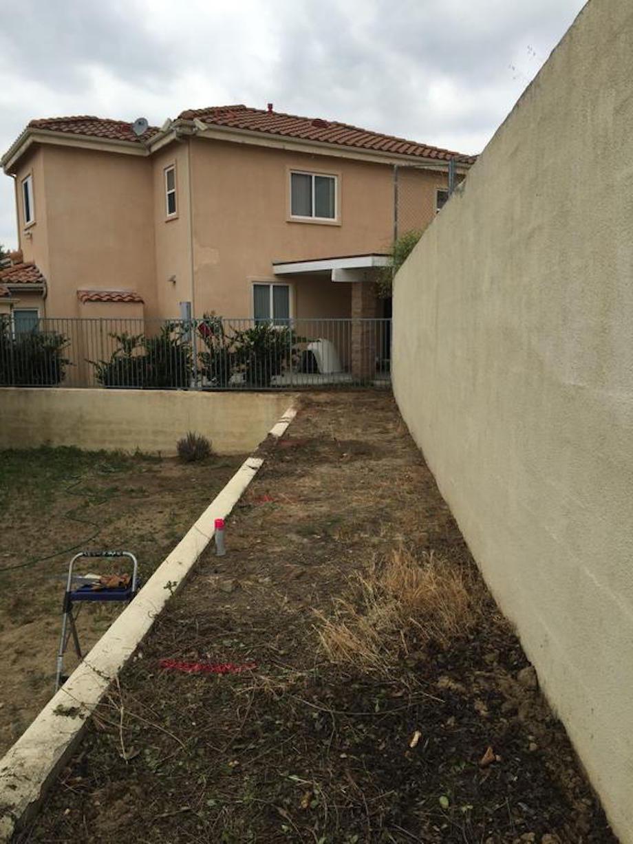 "Looking towards my neighbor's house where there are three military dogs that try to bite me and my little girls every time we get close to the fence. I'll be adding a barrier."