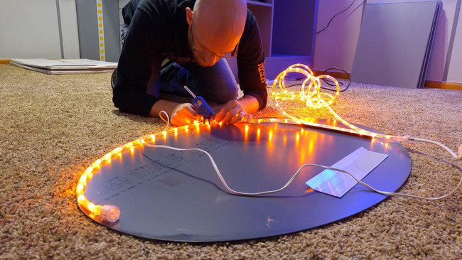 For a cool centerpiece, Slavey used mirrors and colored rope lights to create "portals" in the room.
