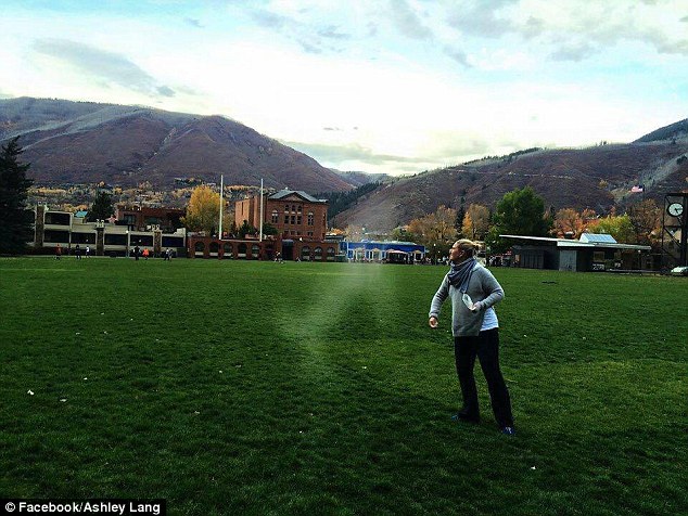 Angel dog: Ashley Lang (pictured), of Chicago, was spreading the ashes of her beloved golden retriever, Wagner, when a friend snapped this photo, which appears to show the silhouette of a dog leaping up at her