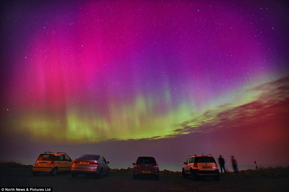 Residents of Allonby  are shown enjoying the dramatic explosion of colour in the skies above the Cumbrian location