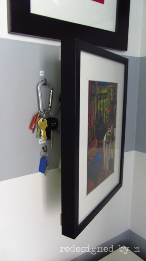 Hang your wall art up on a hinge to create a small compartment space behind it. 